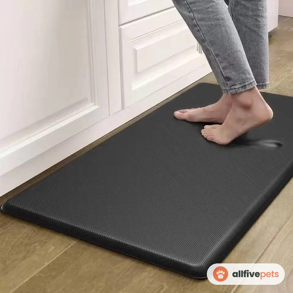 The grey anti-fatigue mat in front of a kitchen counter, in use